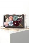 Zierliche, durchscheinende Clutch mit 3D-Blumenmuster in Schwarz