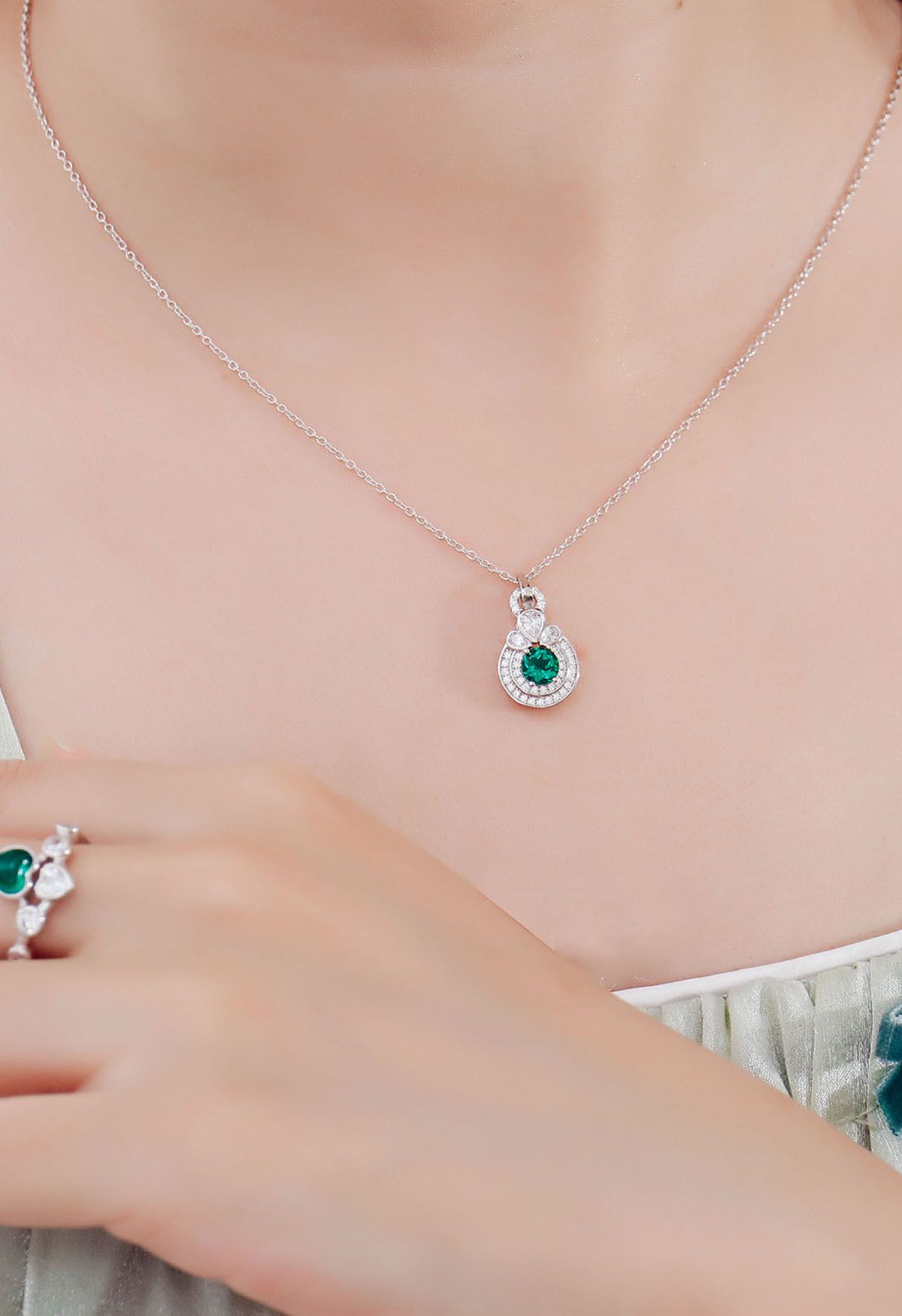 Abgerundete Halo-Smaragd-Diamant-Halskette