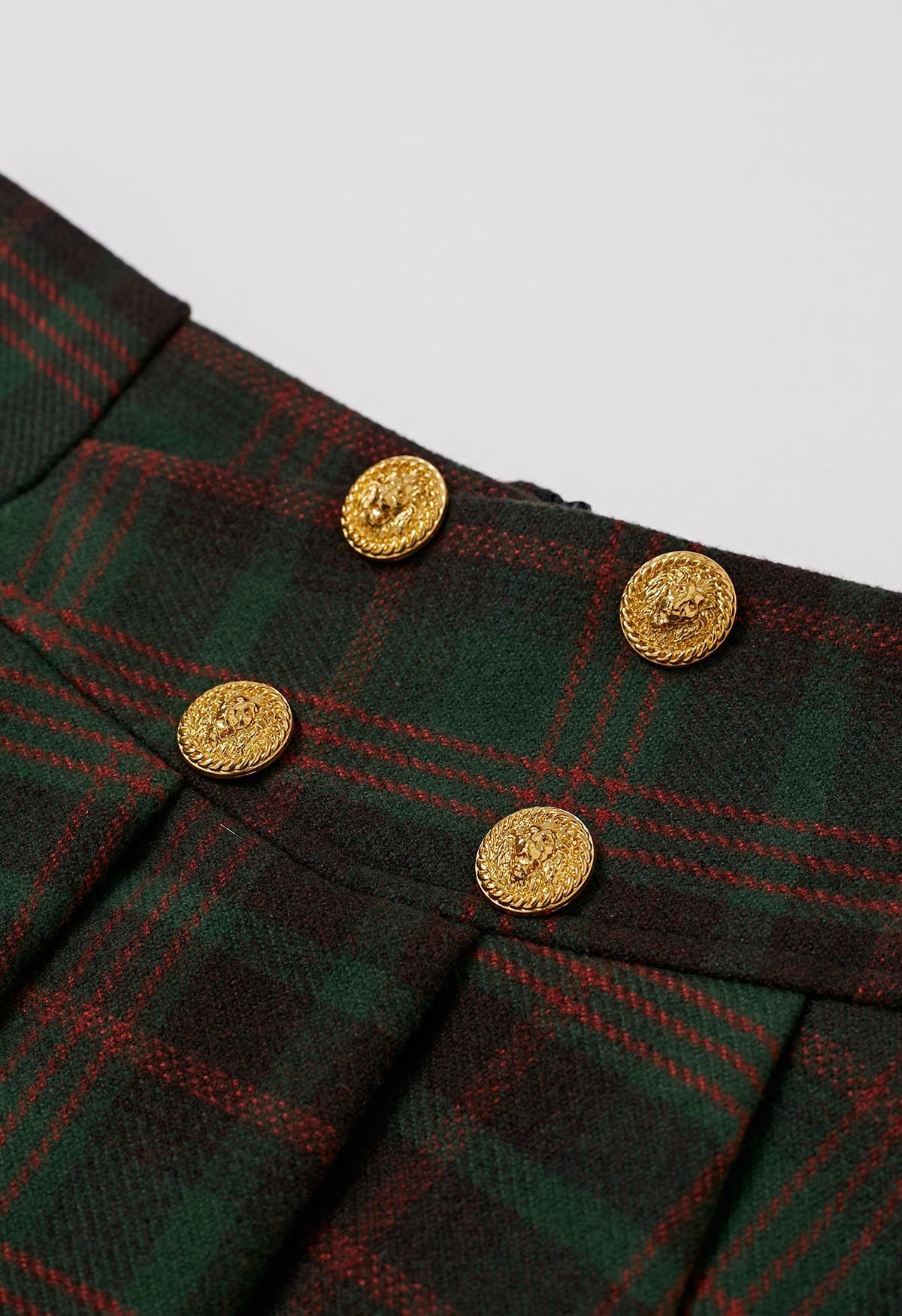 Plissee-Minirock aus Wollmischung mit goldenen Knöpfen in grünem Karomuster