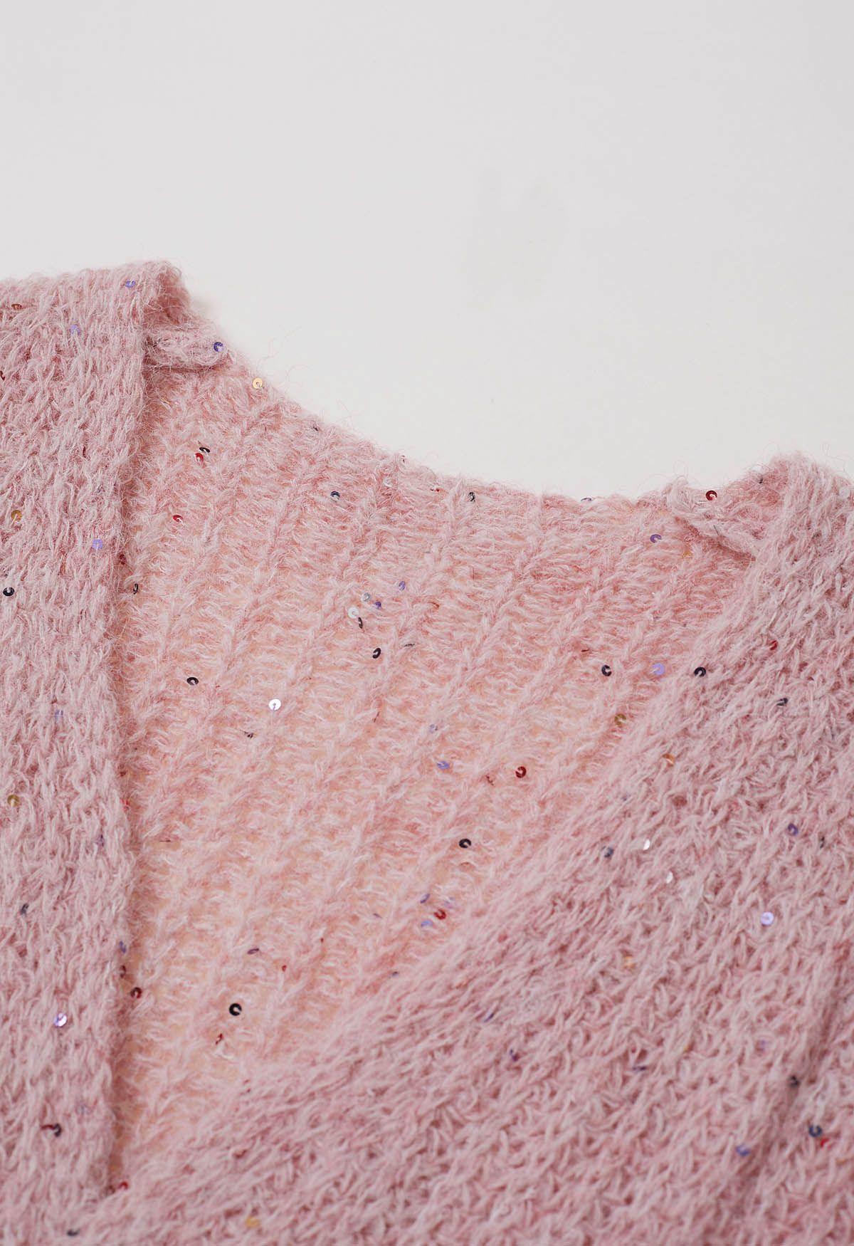 Gemütliche Strickjacke mit offener Vorderseite und bunten Pailletten in Pink