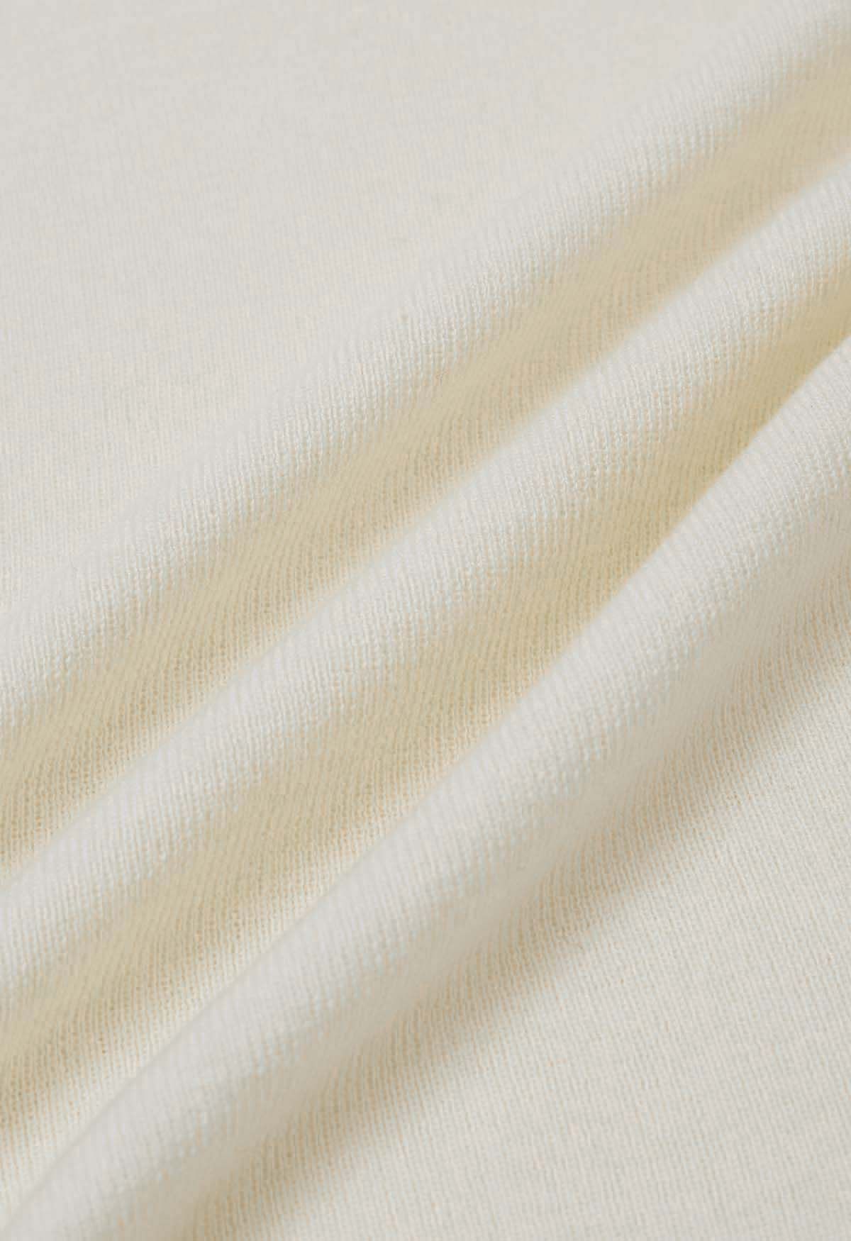 Strickoberteil mit Flügelärmeln und Schleife am Ausschnitt in Creme