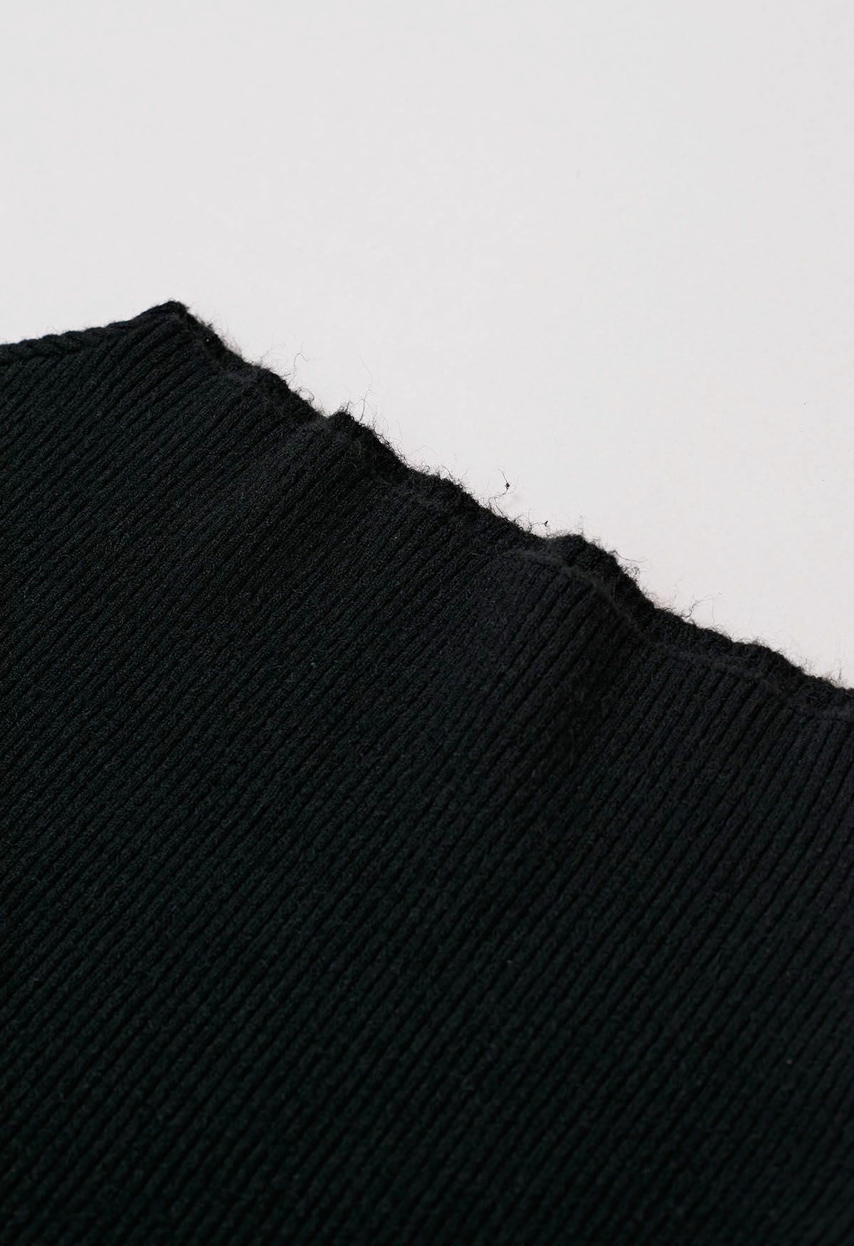 Geripptes Stricktop mit schrägem Saum in Schwarz