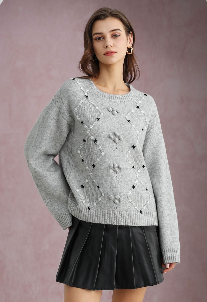 Grauer Rippstrickpullover mit Blumenmuster und Rauten-Pom-Pom