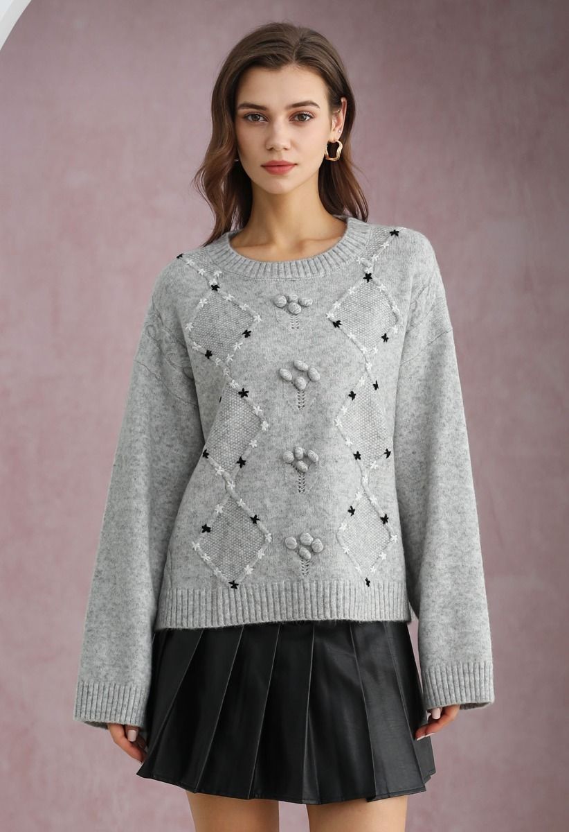 Grauer Rippstrickpullover mit Blumenmuster und Rauten-Pom-Pom