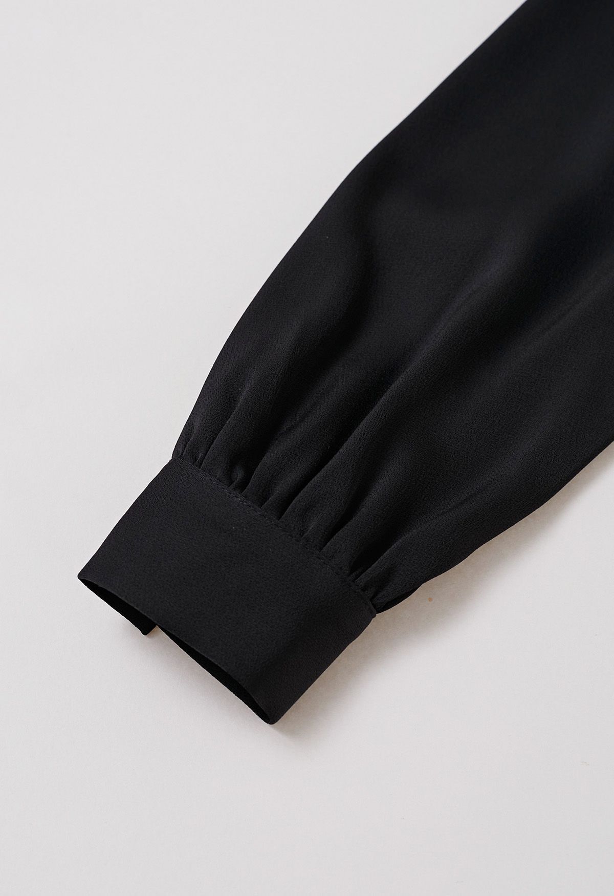 Satin-Top mit V-Ausschnitt, gedrehtem Detail und Schleife in Schwarz